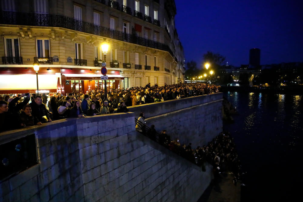 People watch Notre Dame cathedral burning from the Seine river banks in Paris, Monday, April 15, 2019. A catastrophic fire engulfed the upper reaches of Paris' soaring Notre Dame Cathedral as it was undergoing renovations Monday, threatening one of the greatest architectural treasures of the Western world as tourists and Parisians looked on aghast from the streets below. (AP Photo/Francois Mori) People watch Notre Dame cathedral burning from the Seine river banks in Paris, Monday, April 15, 2019. A catastrophic fire engulfed the upper reaches of Paris' soaring Notre Dame Cathedral as it was undergoing renovations Monday, threatening one of the greatest architectural treasures of the Western world as tourists and Parisians looked on aghast from the streets below. (AP Photo/Francois Mori)