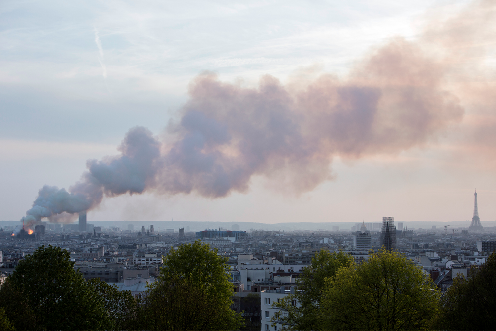 Smoke fill the air as Notre Dame cathedral is burning in Paris, Monday, April 15, 2019. Massive plumes of yellow brown smoke is filling the air above Notre Dame Cathedral and ash is falling on tourists and others around the island that marks the center of Paris. (AP Photo/Rafael Yaghobzadeh) Smoke fill the air as Notre Dame cathedral is burning in Paris, Monday, April 15, 2019. Massive plumes of yellow brown smoke is filling the air above Notre Dame Cathedral and ash is falling on tourists and others around the island that marks the center of Paris. (AP Photo/Rafael Yaghobzadeh)
