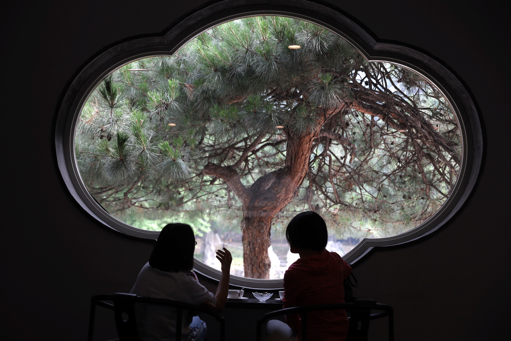 Visitors enjoy the scene from a window of the Xiangshan hotel designed by Chinese-American architect I.M. Pei and built in 1982 in Beijing, China on Friday, May 17, 2019. Pei, the globe-trotting architect who revived the Louvre museum in Paris with a giant glass pyramid and captured the spirit of rebellion at the multi-shaped Rock and Roll Hall of Fame, has died at age 102, a spokesman confirmed Thursday. (AP Photos/Ng Han Guan) Visitors enjoy the scene from a window of the Xiangshan hotel designed by Chinese-American architect I.M. Pei and built in 1982 in Beijing, China on Friday, May 17, 2019. Pei, the globe-trotting architect who revived the Louvre museum in Paris with a giant glass pyramid and captured the spirit of rebellion at the multi-shaped Rock and Roll Hall of Fame, has died at age 102, a spokesman confirmed Thursday. (AP Photos/Ng Han Guan)