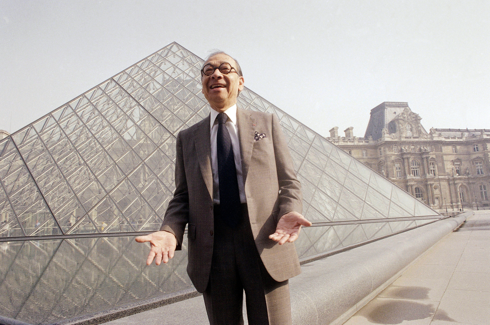 FILE - In this March 29, 1989, file photo, Chinese-American architect I.M. Pei laughs while posing for a portrait in front of the Louvre glass pyramid, which he designed, in the museum's Napoleon Courtyard, prior to its inauguration in Paris. Pei, the globe-trotting architect who revived the Louvre museum in Paris with a giant glass pyramid and captured the spirit of rebellion at the multi-shaped Rock and Roll Hall of Fame, has died at age 102, a spokesman confirmed Thursday, May 16, 2019. (AP Photo/Pierre Gleizes, File) FILE - In this March 29, 1989, file photo, Chinese-American architect I.M. Pei laughs while posing for a portrait in front of the Louvre glass pyramid, which he designed, in the museum's Napoleon Courtyard, prior to its inauguration in Paris. Pei, the globe-trotting architect who revived the Louvre museum in Paris with a giant glass pyramid and captured the spirit of rebellion at the multi-shaped Rock and Roll Hall of Fame, has died at age 102, a spokesman confirmed Thursday, May 16, 2019. (AP Photo/Pierre Gleizes, File)