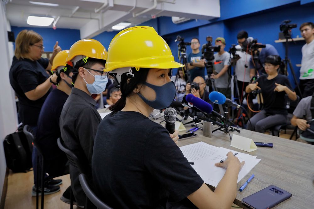 Protesters from right, Mary Tsang, Linus Kim and Jerry Chan listen to a question from a reporter during a press conference in Hong Kong, Tuesday, Aug. 6, 2019. Hong Kong protesters Tuesday condemned what they called the government's Protesters from right, Mary Tsang, Linus Kim and Jerry Chan listen to a question from a reporter during a press conference in Hong Kong, Tuesday, Aug. 6, 2019. Hong Kong protesters Tuesday condemned what they called the government's
