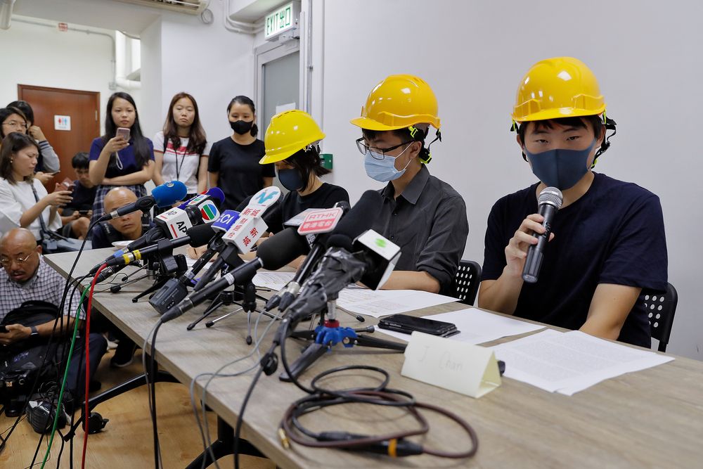 Protesters from right, Jerry Chan, Linus Kim and Mary Tsang attend a press conference in Hong Kong, Tuesday, Aug. 6, 2019. They condemned what they call the government's Protesters from right, Jerry Chan, Linus Kim and Mary Tsang attend a press conference in Hong Kong, Tuesday, Aug. 6, 2019. They condemned what they call the government's