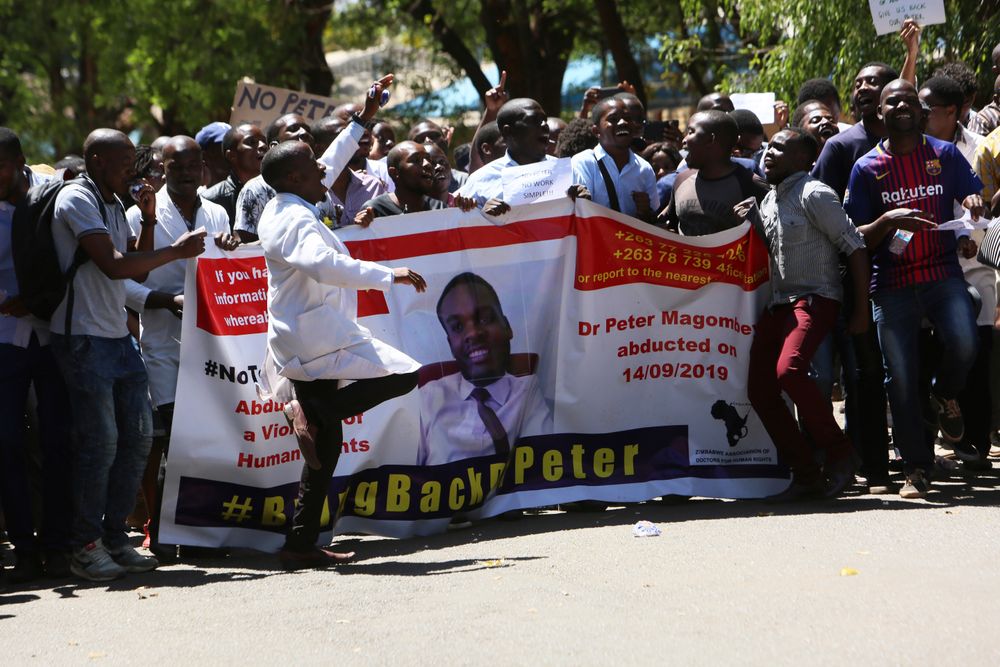 Zimbabwean doctors sing and dance as they protest in Harare, Wednesday, Sept, 18, 2019. Zimbabwean doctors protesting the alleged abduction of a union leader were met by a line of baton- wielding police in the capital as fears grow about government repression. (AP Photo/Tsvangirayi Mukwazhi) Zimbabwean doctors sing and dance as they protest in Harare, Wednesday, Sept, 18, 2019. Zimbabwean doctors protesting the alleged abduction of a union leader were met by a line of baton- wielding police in the capital as fears grow about government repression. (AP Photo/Tsvangirayi Mukwazhi)