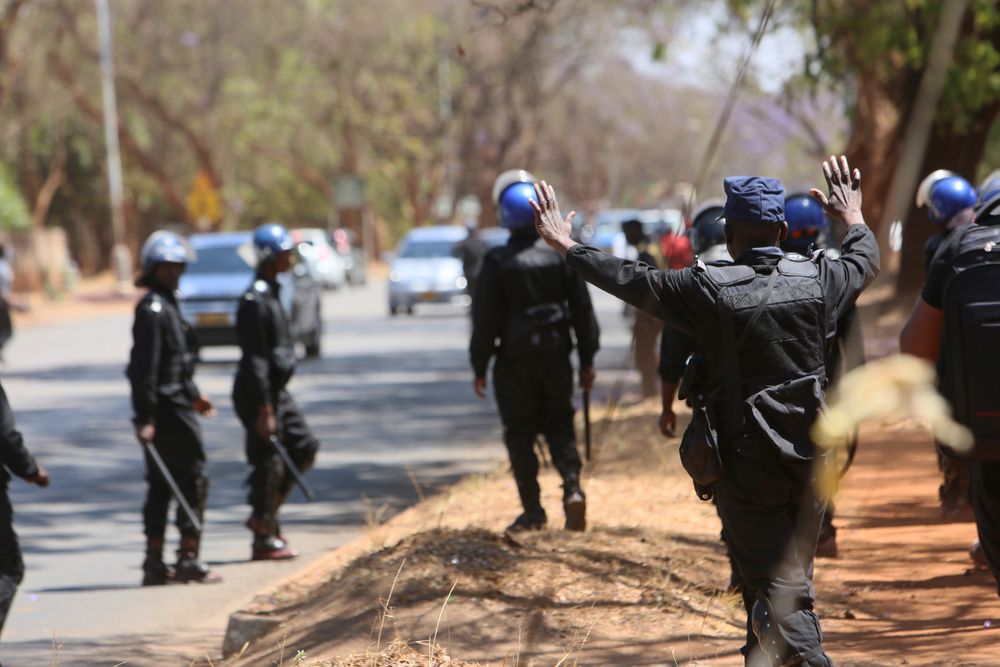 Armed riot police block doctors as they protest in Harare, Wednesday, Sept, 18, 2019. Zimbabwean doctors protesting the alleged abduction of a union leader were met by a line of baton- wielding police in the capital as fears grow about government repression. (AP Photo/Tsvangirayi Mukwazhi) Armed riot police block doctors as they protest in Harare, Wednesday, Sept, 18, 2019. Zimbabwean doctors protesting the alleged abduction of a union leader were met by a line of baton- wielding police in the capital as fears grow about government repression. (AP Photo/Tsvangirayi Mukwazhi)