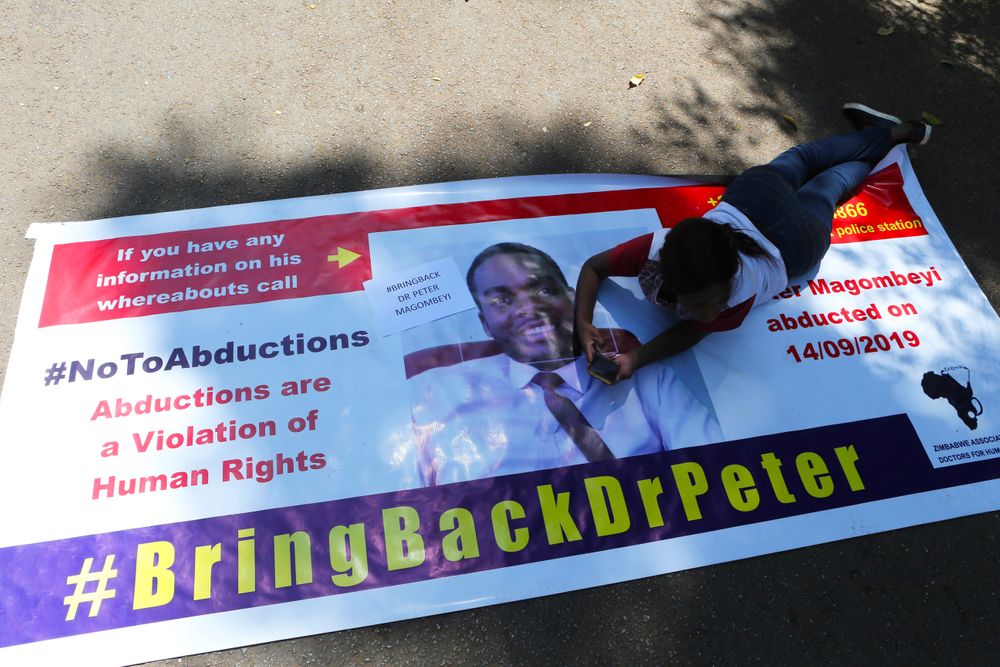A Zimbabwean doctor lays on a banner during a protest in Harare, Wednesday, Sept, 18, 2019. Zimbabwean doctors protesting the alleged abduction of a union leader were met by a line of baton- wielding police in the capital as fears grow about government repression. (AP Photo/Tsvangirayi Mukwazhi) A Zimbabwean doctor lays on a banner during a protest in Harare, Wednesday, Sept, 18, 2019. Zimbabwean doctors protesting the alleged abduction of a union leader were met by a line of baton- wielding police in the capital as fears grow about government repression. (AP Photo/Tsvangirayi Mukwazhi)