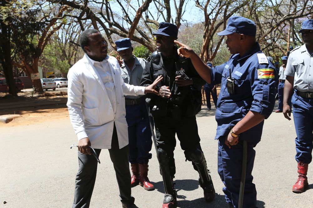 A Zimbabwean doctor is told to retreat after attempting to march in Harare, Wednesday, Sept, 18, 2019. Zimbabwean doctors protesting the alleged abduction of a union leader were met by a line of baton- wielding police in the capital as fears grow about government repression. (AP Photo/Tsvangirayi Mukwazhi) A Zimbabwean doctor is told to retreat after attempting to march in Harare, Wednesday, Sept, 18, 2019. Zimbabwean doctors protesting the alleged abduction of a union leader were met by a line of baton- wielding police in the capital as fears grow about government repression. (AP Photo/Tsvangirayi Mukwazhi)