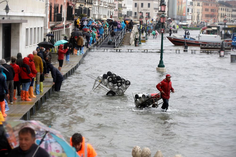 People walk on catwalks set up on the occasion of a high tide, in a flooded Venice, Italy, Tuesday, Nov. 12, 2019. The high tide reached a peak of 127cm (4.1ft) at 10:35am while an even higher level of 140cm(4.6ft) was predicted for later Tuesday evening. (AP Photo/Luca Bruno) People walk on catwalks set up on the occasion of a high tide, in a flooded Venice, Italy, Tuesday, Nov. 12, 2019. The high tide reached a peak of 127cm (4.1ft) at 10:35am while an even higher level of 140cm(4.6ft) was predicted for later Tuesday evening. (AP Photo/Luca Bruno)