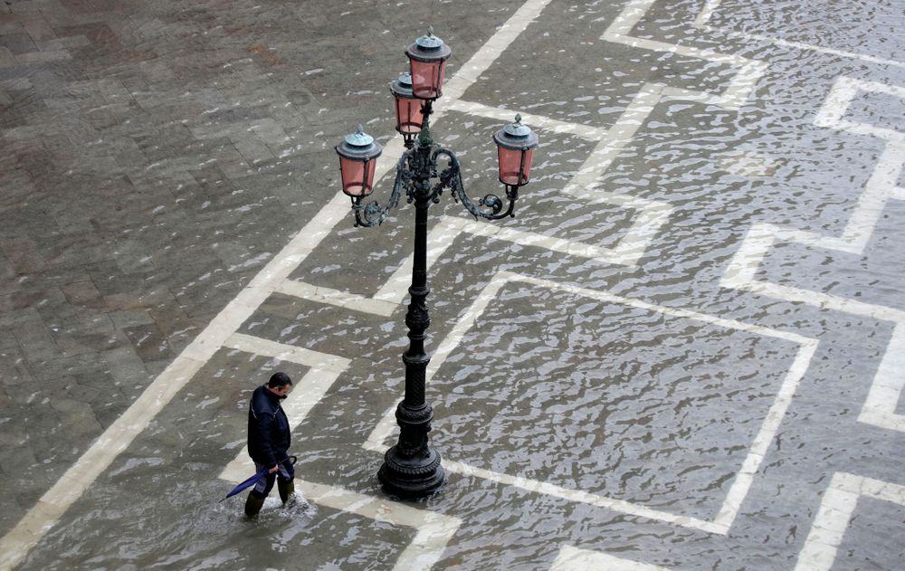 A man walks in a flooded St. Mark's Square in Venice, Italy, Tuesday, Nov. 12, 2019. The high tide reached a peak of 127cm (4.1ft) at 10:35am while an even higher level of 140cm(4.6ft) was predicted for later Tuesday evening. (AP Photo/Luca Bruno) A man walks in a flooded St. Mark's Square in Venice, Italy, Tuesday, Nov. 12, 2019. The high tide reached a peak of 127cm (4.1ft) at 10:35am while an even higher level of 140cm(4.6ft) was predicted for later Tuesday evening. (AP Photo/Luca Bruno)