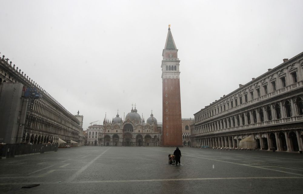 A greengrocer carries his cart as the water begins to flood St. Mark's Square on the occasion of a high tide, in Venice, Italy, Tuesday, Nov. 12, 2019. The high tide reached a peak of 127cm (4.1ft) at 10:35am while an even higher level of 140cm(4.6ft) was predicted for later Tuesday evening. (AP Photo/Luca Bruno) A greengrocer carries his cart as the water begins to flood St. Mark's Square on the occasion of a high tide, in Venice, Italy, Tuesday, Nov. 12, 2019. The high tide reached a peak of 127cm (4.1ft) at 10:35am while an even higher level of 140cm(4.6ft) was predicted for later Tuesday evening. (AP Photo/Luca Bruno)