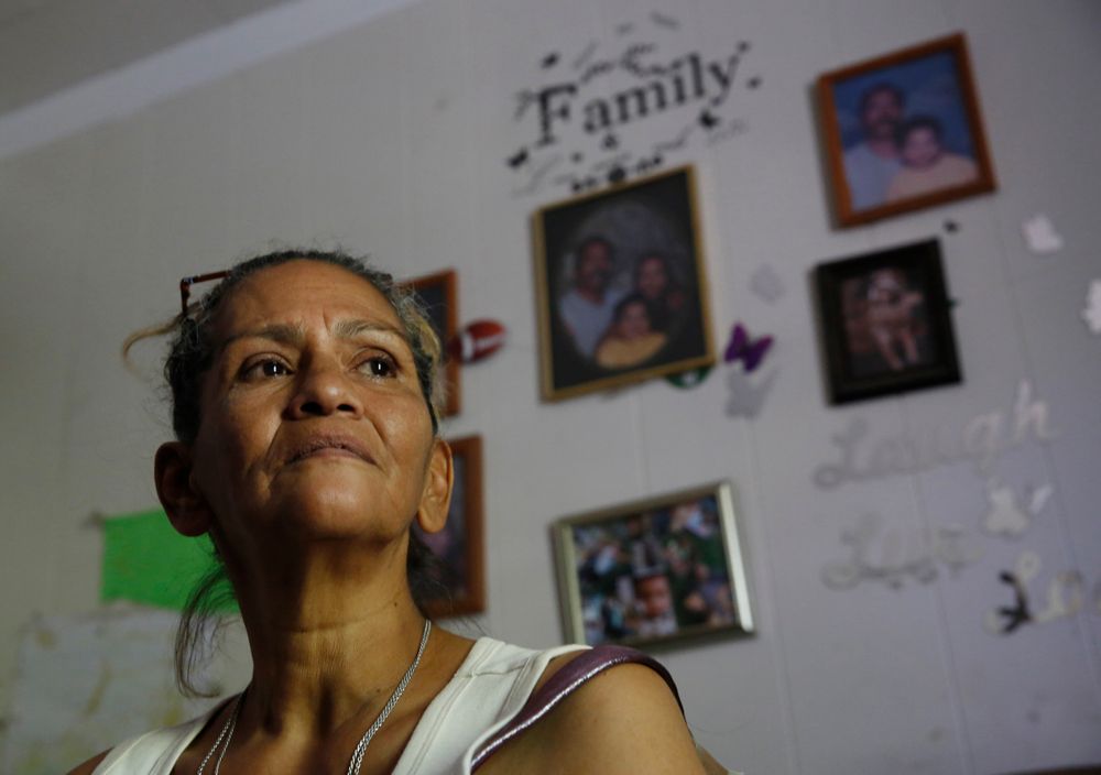 In this photo taken Wednesday, Aug. 14, 2019, Susie Garza, who receives a city provided debit card through the Stockton Economic Empowerment Demonstration she receives monthly through a trial program poses in her home in Stockton, Calif. The program, which started in February, gives $500 a month to 125 people who earn at or below the median household income of $46,033. They can spend the money with no restrictions. Stockton Mayor Michael Tubbs, who initiated the privately funded program, says it could be a solution to the city's poverty problem. (AP Photo/Rich Pedroncelli) In this photo taken Wednesday, Aug. 14, 2019, Susie Garza, who receives a city provided debit card through the Stockton Economic Empowerment Demonstration she receives monthly through a trial program poses in her home in Stockton, Calif. The program, which started in February, gives $500 a month to 125 people who earn at or below the median household income of $46,033. They can spend the money with no restrictions. Stockton Mayor Michael Tubbs, who initiated the privately funded program, says it could be a solution to the city's poverty problem. (AP Photo/Rich Pedroncelli)