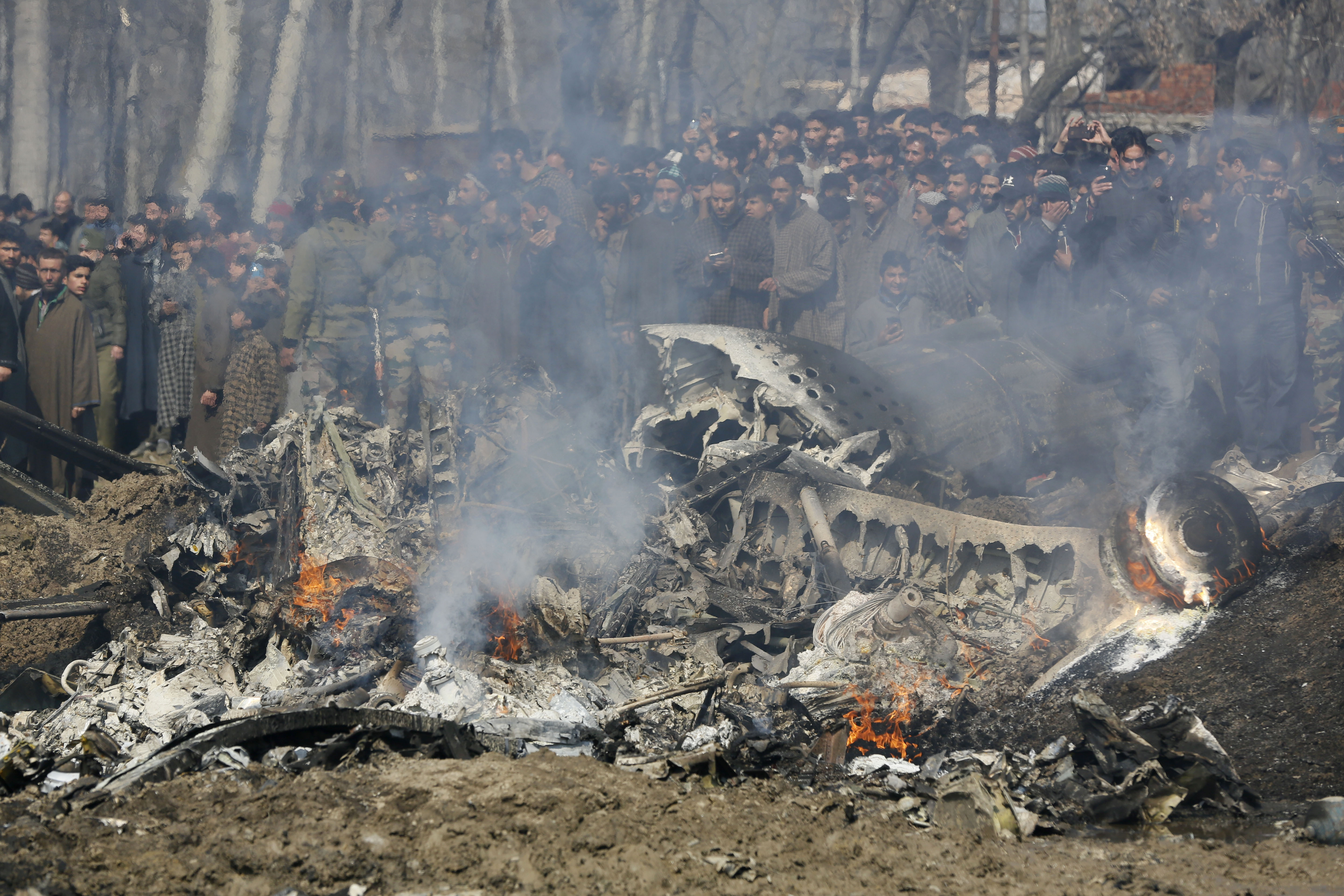 Kashmiri villagers gather near the wreckage of an Indian aircraft after it crashed in Budgam area, outskirts of Srinagar, Indian controlled Kashmir, Wednesday, Feb.27, 2019. (AP Photo/Mukhtar Khan) Kashmiri villagers gather near the wreckage of an Indian aircraft after it crashed in Budgam area, outskirts of Srinagar, Indian controlled Kashmir, Wednesday, Feb.27, 2019. (AP Photo/Mukhtar Khan)