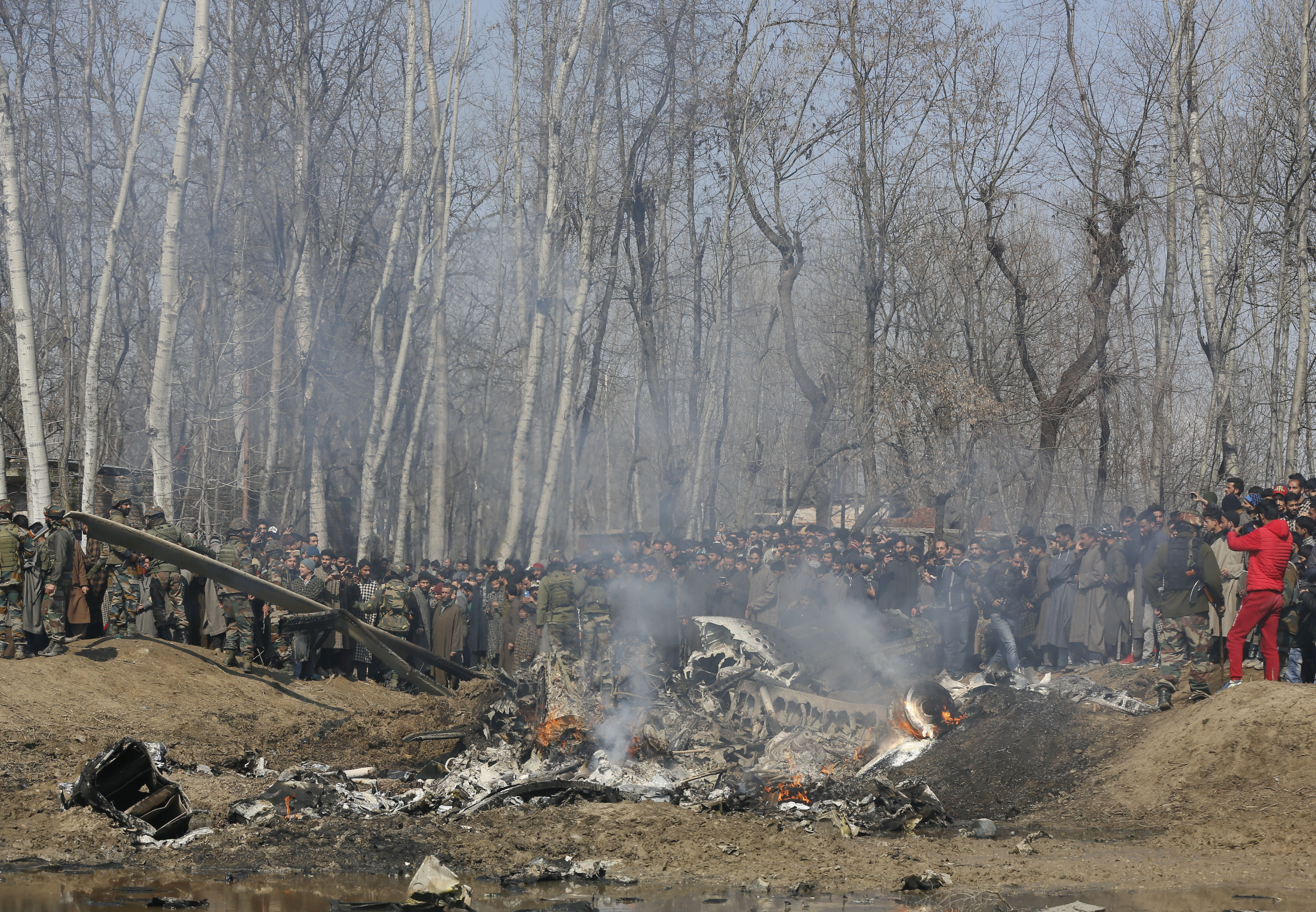 Kashmiri villagers gather near the wreckage of an Indian aircraft after it crashed in Budgam area, outskirts of Srinagar, Indian controlled Kashmir, Wednesday, Feb.27, 2019. (AP Photo/Mukhtar Khan) Kashmiri villagers gather near the wreckage of an Indian aircraft after it crashed in Budgam area, outskirts of Srinagar, Indian controlled Kashmir, Wednesday, Feb.27, 2019. (AP Photo/Mukhtar Khan)