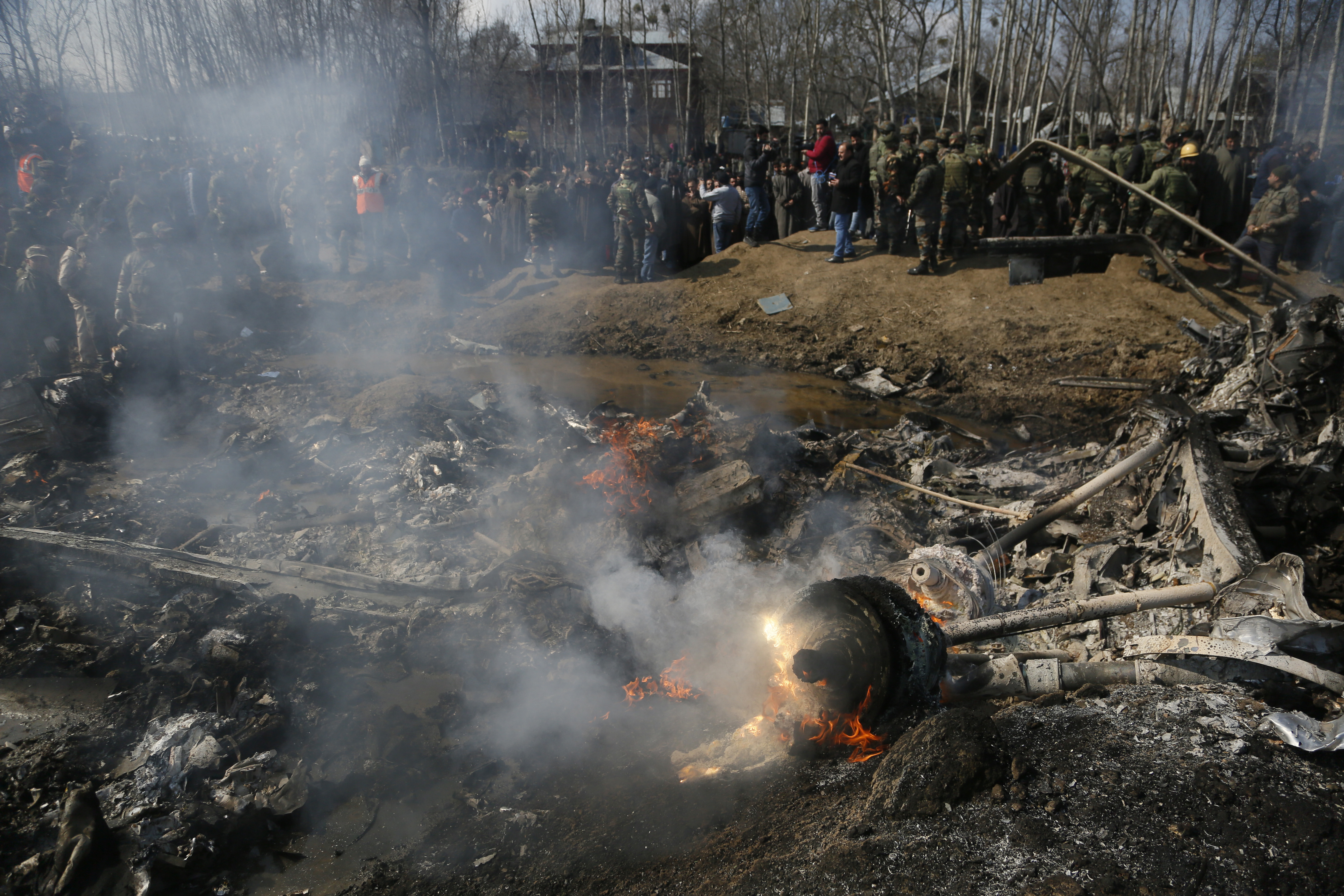 Kashmiri villagers and Indian army soldiers gather near the wreckage of an Indian aircraft after it crashed in Budgam area, outskirts of Srinagar, Indian controlled Kashmir, Wednesday, Feb.27, 2019. (AP Photo/Mukhtar Khan) Kashmiri villagers and Indian army soldiers gather near the wreckage of an Indian aircraft after it crashed in Budgam area, outskirts of Srinagar, Indian controlled Kashmir, Wednesday, Feb.27, 2019. (AP Photo/Mukhtar Khan)