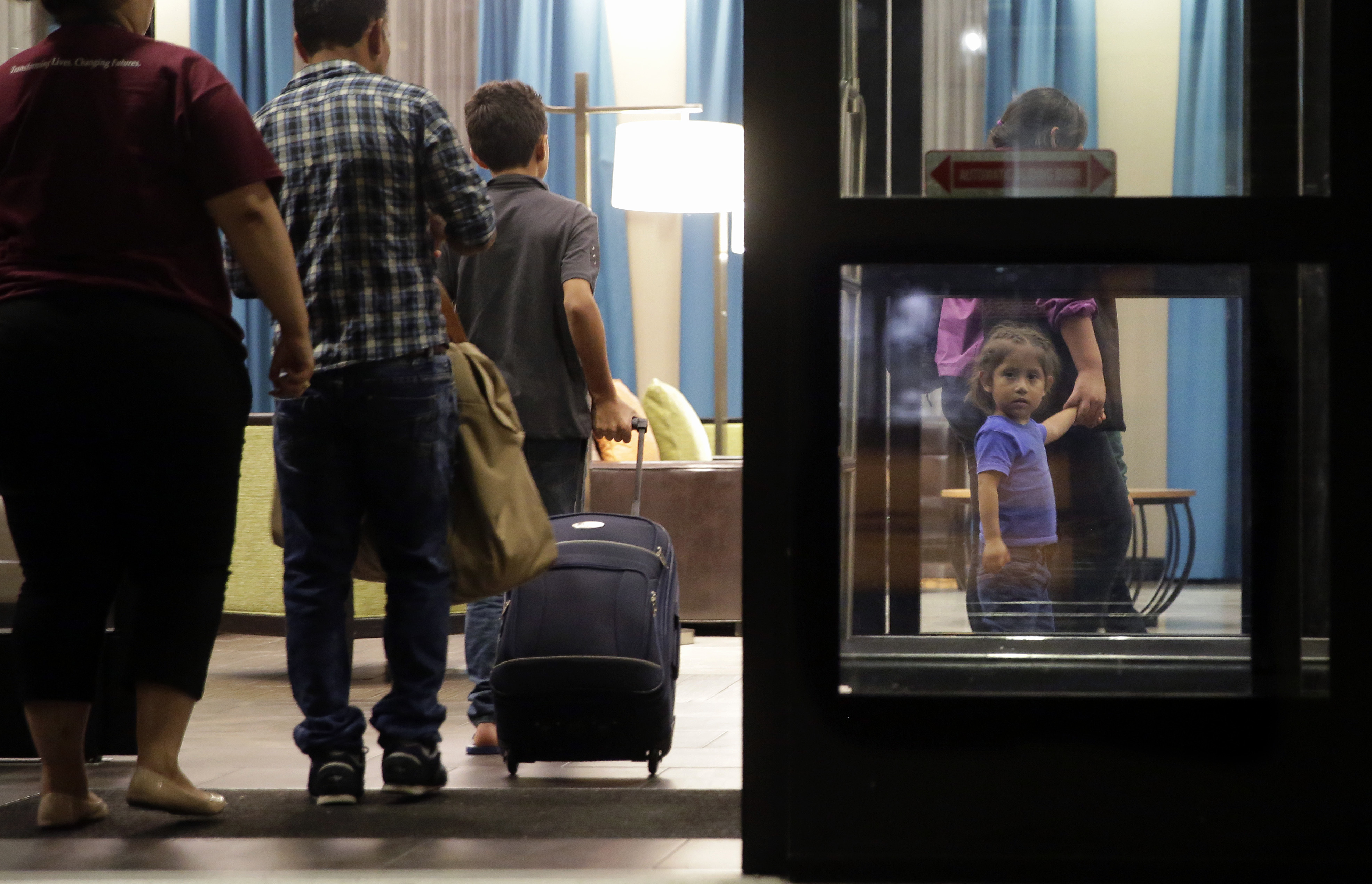 In this Monday, July 23, 2018, file photo, immigrants seeking asylum who were recently reunited arrive at a hotel, in San Antonio. A federal judge says he will give the Trump administration six months to identify children who were separated from their families at the U.S.-Mexico border early in the president's term. U.S. District Judge Dana Sabraw said Thursday, April 25, 2019, in San Diego that it was important to set a deadline for finding potentially thousands of children who were separated between July 1, 2017, and June 25, 2018. (AP Photo/Eric Gay, File) In this Monday, July 23, 2018, file photo, immigrants seeking asylum who were recently reunited arrive at a hotel, in San Antonio. A federal judge says he will give the Trump administration six months to identify children who were separated from their families at the U.S.-Mexico border early in the president's term. U.S. District Judge Dana Sabraw said Thursday, April 25, 2019, in San Diego that it was important to set a deadline for finding potentially thousands of children who were separated between July 1, 2017, and June 25, 2018. (AP Photo/Eric Gay, File)