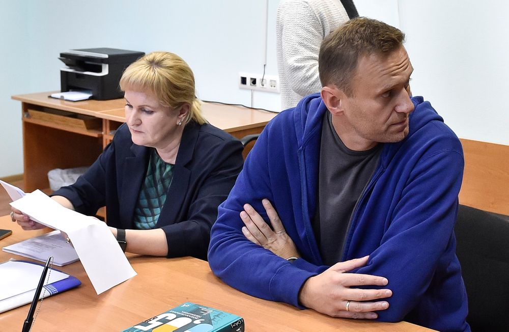 Alexei Navalny, Russia's most prominent opposition figure, who has been detained by police and charged with unlawfully organizing a public gathering, sits in a court room as his lawyer Olga Mikhailova, left, reads documents in Moscow, Russia, Wednesday, July 24, 2019. Navalny has called for demonstrators to protest on Saturday outside the mayor's office against the rejection of several opposition candidates from the ballot for this fall's Moscow city council elections. (AP Photo/Dmitry Serebryakov) Alexei Navalny, Russia's most prominent opposition figure, who has been detained by police and charged with unlawfully organizing a public gathering, sits in a court room as his lawyer Olga Mikhailova, left, reads documents in Moscow, Russia, Wednesday, July 24, 2019. Navalny has called for demonstrators to protest on Saturday outside the mayor's office against the rejection of several opposition candidates from the ballot for this fall's Moscow city council elections. (AP Photo/Dmitry Serebryakov)