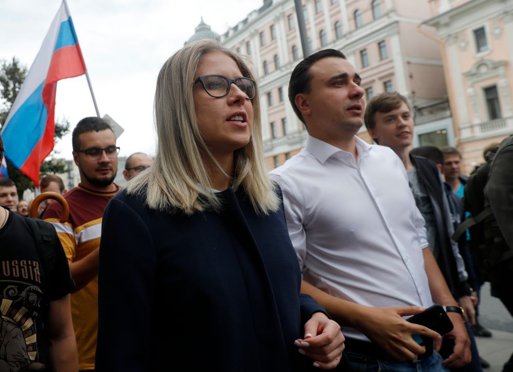 Russian opposition candidate and lawyer at the Foundation for Fighting Corruption Lyubov Sobol, center, attends a protest in Moscow, Russia, Sunday, July 14, 2019. Opposition candidates who run for seats in the city legislature in September's elections have complained that authorities try to bar them from the race by questioning the validity of signatures of city residents they must collect in order to qualify for the race. (AP Photo/Pavel Golovkin) Russian opposition candidate and lawyer at the Foundation for Fighting Corruption Lyubov Sobol, center, attends a protest in Moscow, Russia, Sunday, July 14, 2019. Opposition candidates who run for seats in the city legislature in September's elections have complained that authorities try to bar them from the race by questioning the validity of signatures of city residents they must collect in order to qualify for the race. (AP Photo/Pavel Golovkin)