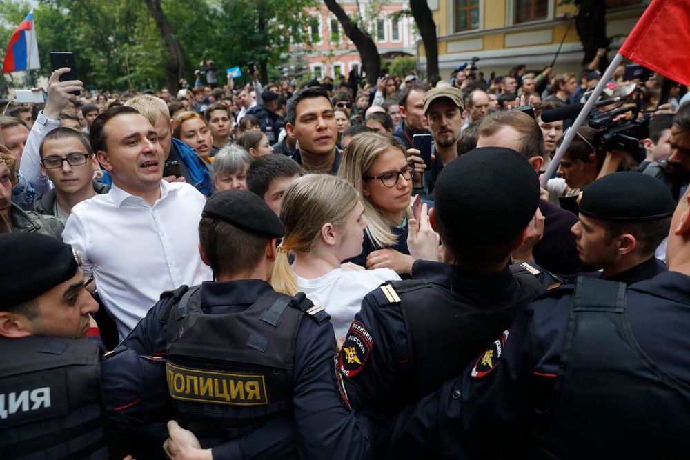Russian opposition candidate and lawyer at the Foundation for Fighting Corruption Lyubov Sobol, center, and candidate Ivan Zhdanov, 2nd left, stand with other protesters in front of police line during a protest in Moscow, Russia, Sunday, July 14, 2019. Around 1,000 people have gathered in central Moscow to demand that opposition candidates be included on ballots for an upcoming city parliament election in September. (AP Photo/Pavel Golovkin) Russian opposition candidate and lawyer at the Foundation for Fighting Corruption Lyubov Sobol, center, and candidate Ivan Zhdanov, 2nd left, stand with other protesters in front of police line during a protest in Moscow, Russia, Sunday, July 14, 2019. Around 1,000 people have gathered in central Moscow to demand that opposition candidates be included on ballots for an upcoming city parliament election in September. (AP Photo/Pavel Golovkin)