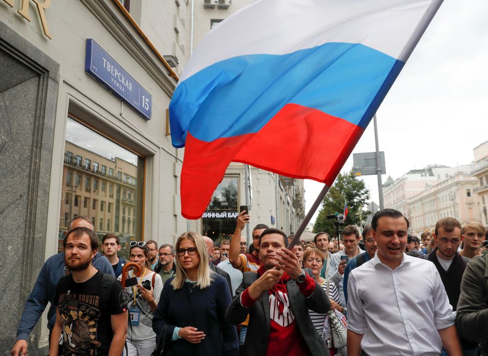 Russian opposition candidate Ilya Yashin, center right, and opposition candidate and lawyer at the Foundation for Fighting Corruption Lyubov Sobol, center left, walk during a protest in Moscow, Russia, Sunday, July 14, 2019. Opposition candidates who run for seats in the city legislature in September's elections have complained that authorities try to bar them from the race by questioning the validity of signatures of city residents they must collect in order to qualify for the race. (AP Photo/Pavel Golovkin) Russian opposition candidate Ilya Yashin, center right, and opposition candidate and lawyer at the Foundation for Fighting Corruption Lyubov Sobol, center left, walk during a protest in Moscow, Russia, Sunday, July 14, 2019. Opposition candidates who run for seats in the city legislature in September's elections have complained that authorities try to bar them from the race by questioning the validity of signatures of city residents they must collect in order to qualify for the race. (AP Photo/Pavel Golovkin)