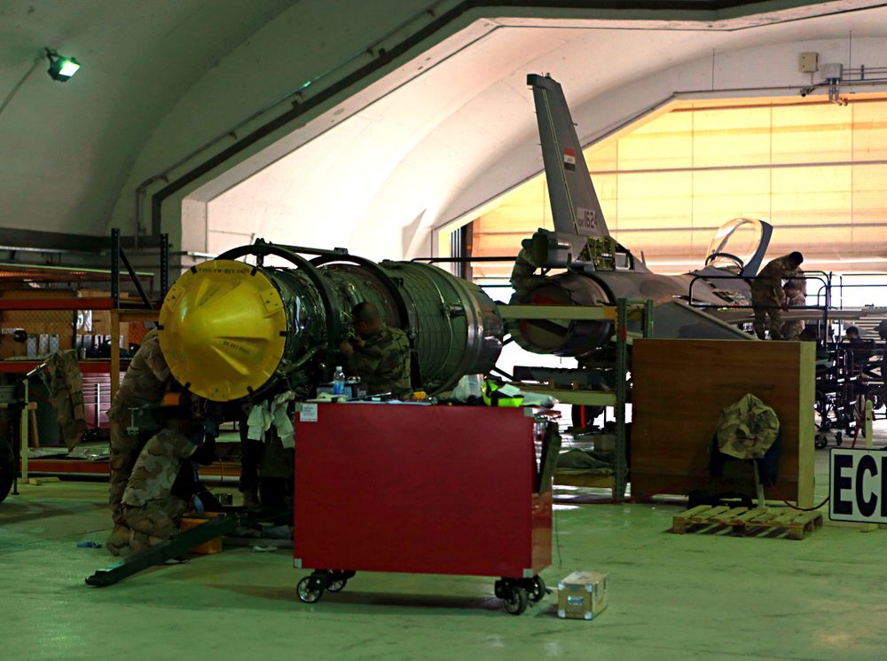 FILE - in this Tuesday, Feb. 13, 2018 file photo, U.S. and Iraqi engineers do engine maintenance of a U.S.- made Iraqi Air Force F-16 fighter jet at the Balad, Iraq. Militants fired early Saturday, June 15, 2019 three mortar shells on an air base just north of Baghdad where American trainers are present, causing a small fires but no casualties, the Iraqi military said. (AP Photo/Khalid Mohammed, File) FILE - in this Tuesday, Feb. 13, 2018 file photo, U.S. and Iraqi engineers do engine maintenance of a U.S.- made Iraqi Air Force F-16 fighter jet at the Balad, Iraq. Militants fired early Saturday, June 15, 2019 three mortar shells on an air base just north of Baghdad where American trainers are present, causing a small fires but no casualties, the Iraqi military said. (AP Photo/Khalid Mohammed, File)