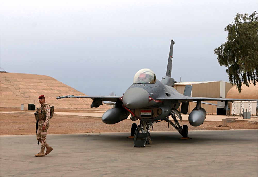 FILE - in this Tuesday, Feb. 13, 2018 file photo, an Iraqi army soldier stand guard near a U.S.- made Iraqi Air Force F-16 fighter jet at the Balad Air Base, Iraq. Militants fired early Saturday, June 15, 2019, three mortar shells on an air base just north of Baghdad where American trainers are present, causing a small fires but no casualties, the Iraqi military said. (AP Photo/Khalid Mohammed, File) FILE - in this Tuesday, Feb. 13, 2018 file photo, an Iraqi army soldier stand guard near a U.S.- made Iraqi Air Force F-16 fighter jet at the Balad Air Base, Iraq. Militants fired early Saturday, June 15, 2019, three mortar shells on an air base just north of Baghdad where American trainers are present, causing a small fires but no casualties, the Iraqi military said. (AP Photo/Khalid Mohammed, File)