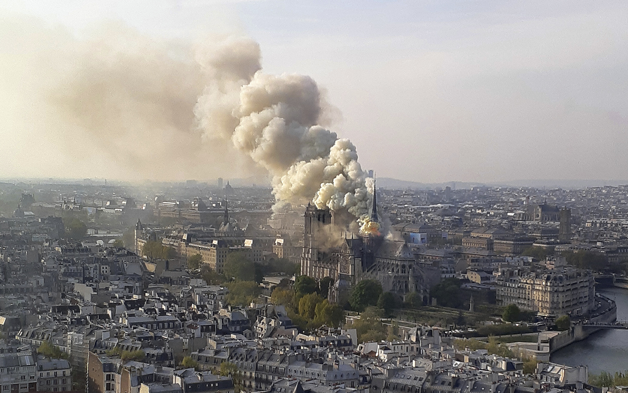 In this image made available on Tuesday April 16, 2019 flames and smoke rise from the blaze at Notre Dame cathedral in Paris, Monday, April 15, 2019. An inferno that raged through Notre Dame Cathedral for more than 12 hours destroyed its spire and its roof but spared its twin medieval bell towers, and a frantic rescue effort saved the monument's In this image made available on Tuesday April 16, 2019 flames and smoke rise from the blaze at Notre Dame cathedral in Paris, Monday, April 15, 2019. An inferno that raged through Notre Dame Cathedral for more than 12 hours destroyed its spire and its roof but spared its twin medieval bell towers, and a frantic rescue effort saved the monument's