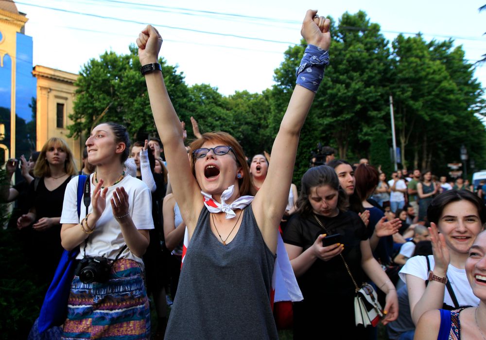 Young opposition demonstrators react while listening an orator as they gather in front of the Georgian Parliament building in Tbilisi, Georgia, Saturday, June 22, 2019. Demonstrators denounced the government Friday as overly friendly to Russia and calling for a snap parliamentary election. (AP Photo/Shakh Aivazov) Young opposition demonstrators react while listening an orator as they gather in front of the Georgian Parliament building in Tbilisi, Georgia, Saturday, June 22, 2019. Demonstrators denounced the government Friday as overly friendly to Russia and calling for a snap parliamentary election. (AP Photo/Shakh Aivazov)