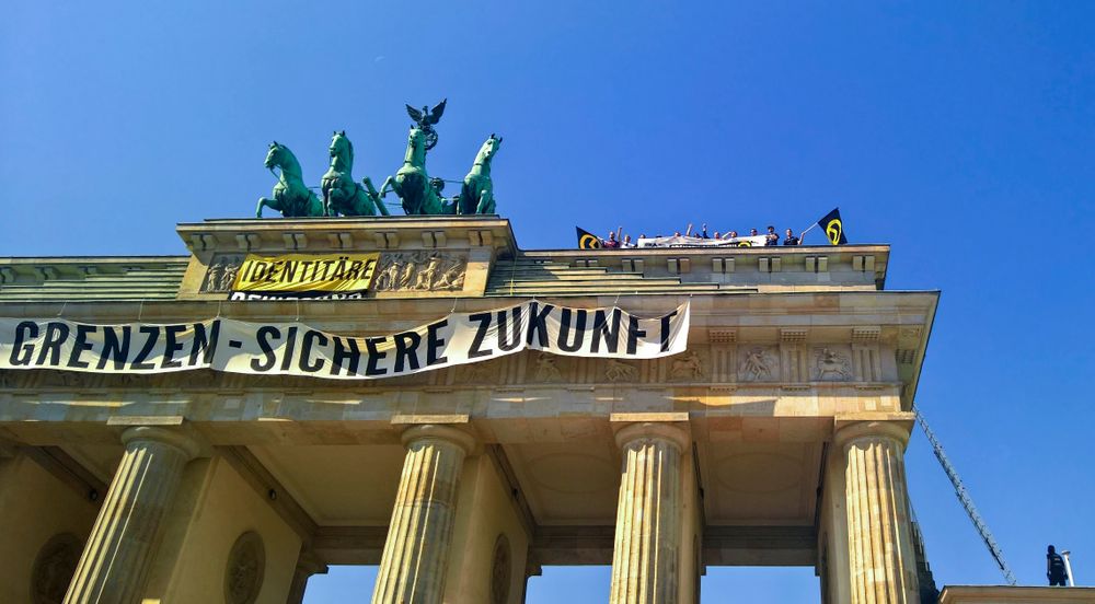 Activists of the Identitarian Movement protest on the Brandenburg Gate with a banner reading 'secure borders - secure fututre'Saturday, Aug. 27, 2016.The German domestic intelligence agency says it is stepping up observation of the far-right Identitarian Movement in Germany that campaigns against immigrants and Islam. (AP Photo/Frank Jordans) Activists of the Identitarian Movement protest on the Brandenburg Gate with a banner reading 'secure borders - secure fututre'Saturday, Aug. 27, 2016.The German domestic intelligence agency says it is stepping up observation of the far-right Identitarian Movement in Germany that campaigns against immigrants and Islam. (AP Photo/Frank Jordans)