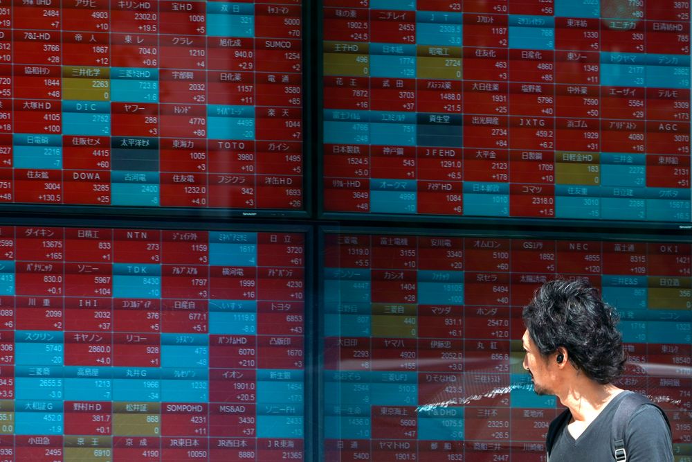 In this Aug. 9, 2019, photo, a man looks at an electronic stock board showing Japan's Nikkei 225 index at a securities firm in Tokyo. Asian shares were mostly higher Wednesday, Aug. 14, 2019 after the U.S. said it would hold off on tariffs of Chinese imports of mobile phones, toys and several other items typically on holiday shopping lists. (AP Photo/Eugene Hoshiko) In this Aug. 9, 2019, photo, a man looks at an electronic stock board showing Japan's Nikkei 225 index at a securities firm in Tokyo. Asian shares were mostly higher Wednesday, Aug. 14, 2019 after the U.S. said it would hold off on tariffs of Chinese imports of mobile phones, toys and several other items typically on holiday shopping lists. (AP Photo/Eugene Hoshiko)