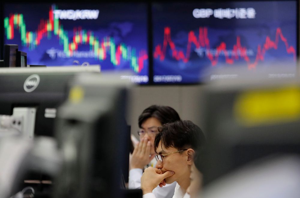 In this Aug. 1, 2019, photo, currency traders watch monitors at the foreign exchange dealing room of the KEB Hana Bank headquarters in Seoul, South Korea. Asian shares were mostly higher Wednesday, Aug. 14, 2019, after the U.S. said it would hold off on tariffs of Chinese imports of mobile phones, toys and several other items typically on holiday shopping lists. (AP Photo/Ahn Young-joon) In this Aug. 1, 2019, photo, currency traders watch monitors at the foreign exchange dealing room of the KEB Hana Bank headquarters in Seoul, South Korea. Asian shares were mostly higher Wednesday, Aug. 14, 2019, after the U.S. said it would hold off on tariffs of Chinese imports of mobile phones, toys and several other items typically on holiday shopping lists. (AP Photo/Ahn Young-joon)