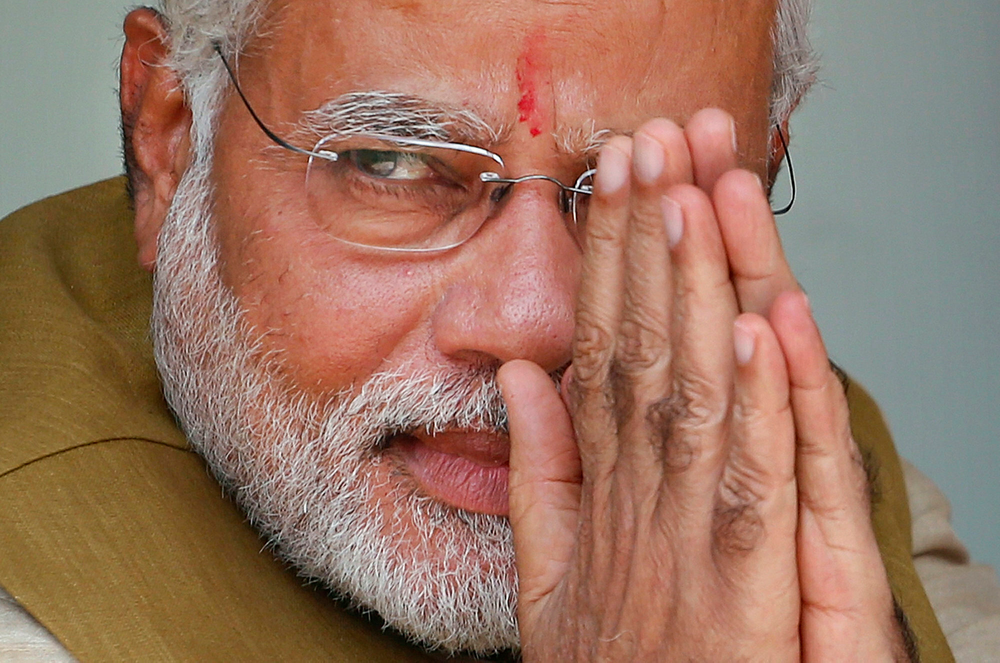 FILE – In this May 16, 2014 file photo, opposition Bharatiya Janata Party (BJP) leader and India's next prime minister Narendra Modi greets the gathering at the home of his 90-year-old mother in Gandhinagar, in the western Indian state of Gujarat. Indian Prime Minister Narendra Modi's party claimed it had won re-election with a commanding lead in vote count Thursday, May 23, 2019. Modi, 68, the leader of the Hindu nationalist Bharatiya Janata Party, has carefully constructed an image of himself as a pious man of the people, a would-be monk called to politics who has elevated India’s status globally and transformed its parliamentary elections from a contest of political parties on social and economic issues into a cult of personality. (AP Photo/Saurabh Das, File) FILE – In this May 16, 2014 file photo, opposition Bharatiya Janata Party (BJP) leader and India's next prime minister Narendra Modi greets the gathering at the home of his 90-year-old mother in Gandhinagar, in the western Indian state of Gujarat. Indian Prime Minister Narendra Modi's party claimed it had won re-election with a commanding lead in vote count Thursday, May 23, 2019. Modi, 68, the leader of the Hindu nationalist Bharatiya Janata Party, has carefully constructed an image of himself as a pious man of the people, a would-be monk called to politics who has elevated India’s status globally and transformed its parliamentary elections from a contest of political parties on social and economic issues into a cult of personality. (AP Photo/Saurabh Das, File)