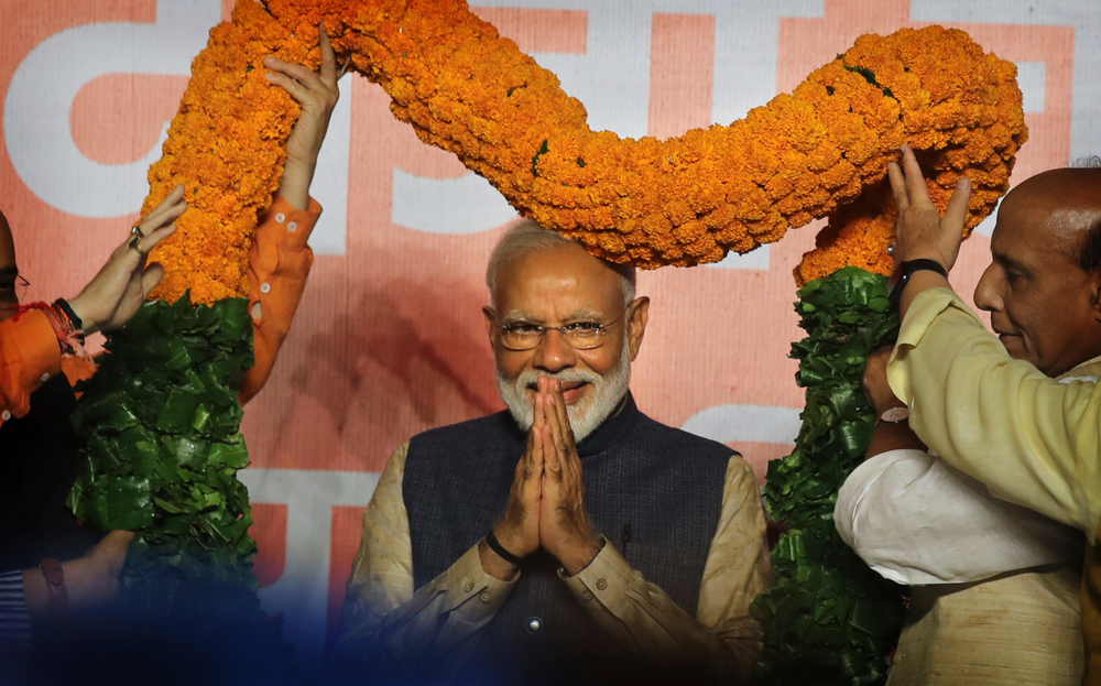 Indian Prime Minister Narendra Modi receives a giant floral garland from party leaders at their headquarters in New Delhi, India, Thursday, May 23, 2019. Indian Prime Minister Narendra Modi's party claimed it had won reelection with a commanding lead in Thursday's vote count, while the stock market soared in anticipation of another five-year term for the pro-business Hindu nationalist leader. (AP Photo/Manish Swarup) Indian Prime Minister Narendra Modi receives a giant floral garland from party leaders at their headquarters in New Delhi, India, Thursday, May 23, 2019. Indian Prime Minister Narendra Modi's party claimed it had won reelection with a commanding lead in Thursday's vote count, while the stock market soared in anticipation of another five-year term for the pro-business Hindu nationalist leader. (AP Photo/Manish Swarup)