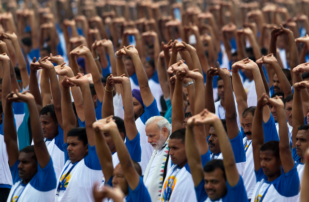 FILE - In this June 21, 2016 file photo, India's Prime Minister Narendra Modi, center,practices yoga along with thousands of Indians to mark the second International Yoga Day, in Chandigarh, India. Indian Prime Minister Narendra Modi's party claimed it had won re-election with a commanding lead in vote count Thursday, May 23, 2019. Modi, 68, the leader of the Hindu nationalist Bharatiya Janata Party, has carefully constructed an image of himself as a pious man of the people, a would-be monk called to politics who has elevated India’s status globally and transformed its parliamentary elections from a contest of political parties on social and economic issues into a cult of personality. (AP Photo/Saurabh Das, File) FILE - In this June 21, 2016 file photo, India's Prime Minister Narendra Modi, center,practices yoga along with thousands of Indians to mark the second International Yoga Day, in Chandigarh, India. Indian Prime Minister Narendra Modi's party claimed it had won re-election with a commanding lead in vote count Thursday, May 23, 2019. Modi, 68, the leader of the Hindu nationalist Bharatiya Janata Party, has carefully constructed an image of himself as a pious man of the people, a would-be monk called to politics who has elevated India’s status globally and transformed its parliamentary elections from a contest of political parties on social and economic issues into a cult of personality. (AP Photo/Saurabh Das, File)
