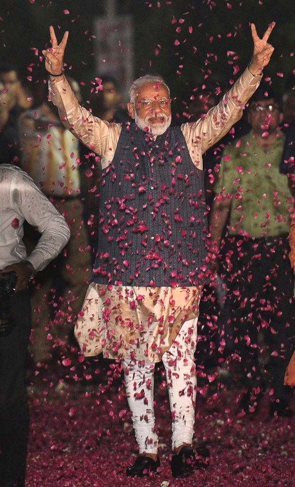 Indian Prime Minister Narendra Modi displays the victory symbol upon arrival at the party headquarters in New Delhi, India, Thursday, May 23, 2019. Modi's Hindu nationalist party claimed it won reelection with a commanding lead in Thursday's vote count, while the head of the main opposition party conceded a personal defeat that signaled the end of an era for modern India's main political dynasty. (AP Photo) Indian Prime Minister Narendra Modi displays the victory symbol upon arrival at the party headquarters in New Delhi, India, Thursday, May 23, 2019. Modi's Hindu nationalist party claimed it won reelection with a commanding lead in Thursday's vote count, while the head of the main opposition party conceded a personal defeat that signaled the end of an era for modern India's main political dynasty. (AP Photo)