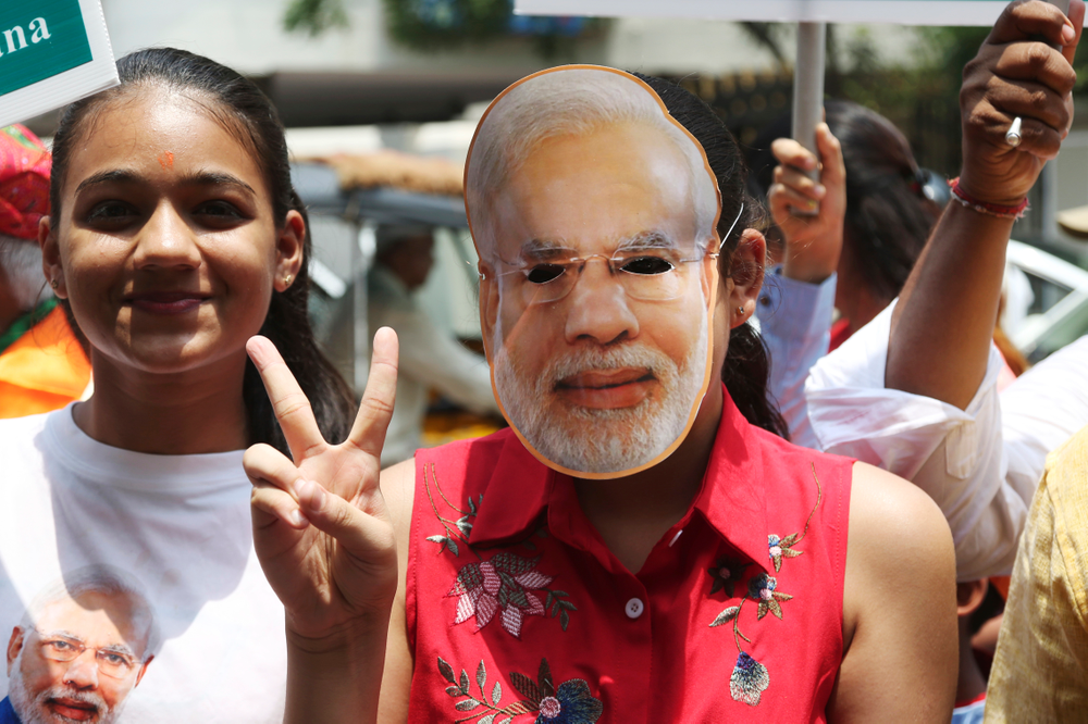 A supporter of India's ruling Bharatiya Janata Party wearing a mask of Indian Prime Minister Narendra Modi shows victory sign as they celebrate early lead in at party's state head quarter in Hyderabad, India, Thursday, May 23, 2019. Modi and his party were off to an early lead as vote counting began Thursday following the conclusion of the country's 6-week-long general election, sending the stock market soaring in anticipation of another five-year term for the Hindu nationalist leader.(AP Photo/Mahesh Kumar A.) A supporter of India's ruling Bharatiya Janata Party wearing a mask of Indian Prime Minister Narendra Modi shows victory sign as they celebrate early lead in at party's state head quarter in Hyderabad, India, Thursday, May 23, 2019. Modi and his party were off to an early lead as vote counting began Thursday following the conclusion of the country's 6-week-long general election, sending the stock market soaring in anticipation of another five-year term for the Hindu nationalist leader.(AP Photo/Mahesh Kumar A.)