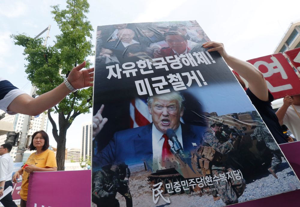 A protester carries a board during a rally to oppose a joint military exercise between South Korea and the United States near the U.S. embassy in Seoul, South Korea, Tuesday, Aug. 6, 2019. North Korea on Tuesday continued to ramp up its weapons demonstrations by firing unidentified projectiles twice into the sea while lashing out at the United States and South Korea for continuing their joint military exercises that the North says could derail fragile nuclear diplomacy. The sign reads A protester carries a board during a rally to oppose a joint military exercise between South Korea and the United States near the U.S. embassy in Seoul, South Korea, Tuesday, Aug. 6, 2019. North Korea on Tuesday continued to ramp up its weapons demonstrations by firing unidentified projectiles twice into the sea while lashing out at the United States and South Korea for continuing their joint military exercises that the North says could derail fragile nuclear diplomacy. The sign reads