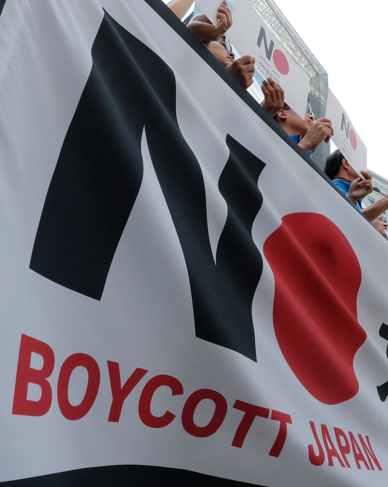 Members of the Confederation of Korean Government Employees' Unions hold banners near the Japanese embassy in Seoul, South Korea, Tuesday, Aug. 6, 2019. South Korea's president on Monday described the country's escalating trade war with Japan as a wake-up call to revamp its economy and issued a nationalistic call for economic cooperation with North Korea, which he said would allow the Koreas to erase Japan's economic superiority in Members of the Confederation of Korean Government Employees' Unions hold banners near the Japanese embassy in Seoul, South Korea, Tuesday, Aug. 6, 2019. South Korea's president on Monday described the country's escalating trade war with Japan as a wake-up call to revamp its economy and issued a nationalistic call for economic cooperation with North Korea, which he said would allow the Koreas to erase Japan's economic superiority in