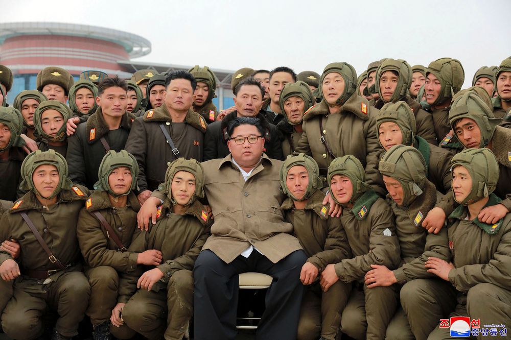 In this undated photo provided on Monday, Nov. 18, 2019, by the North Korean government, North Korean leader Kim Jong Un, center, poses with North Korean air force sharpshooters and soldiers for a photo at an unknown location in North Korea. Kim supervised a parachuting drill of military sharpshooters and vowed to build an “invincible army,” displaying more defiance even as the United States and South Korea called off their own exercises to create space for nuclear diplomacy. Independent journalists were not given access to cover the event depicted in this image distributed by the North Korean government. The content of this image is as provided and cannot be independently verified. Korean language watermark on image as provided by source reads: In this undated photo provided on Monday, Nov. 18, 2019, by the North Korean government, North Korean leader Kim Jong Un, center, poses with North Korean air force sharpshooters and soldiers for a photo at an unknown location in North Korea. Kim supervised a parachuting drill of military sharpshooters and vowed to build an “invincible army,” displaying more defiance even as the United States and South Korea called off their own exercises to create space for nuclear diplomacy. Independent journalists were not given access to cover the event depicted in this image distributed by the North Korean government. The content of this image is as provided and cannot be independently verified. Korean language watermark on image as provided by source reads: