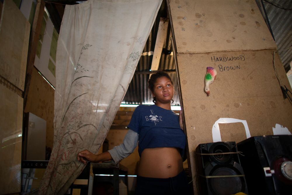 In this photo taken Aug. 5, 2019, 14-year-old Rosibeth Vargas, who is seven months pregnant, stands in her home where she lives with her parents, 18-year-old sister and nephew, in the Tablitas area of the Caucaguita neighborhood on the outskirts of Caracas, Venezuela. Vargas said her school allows student mothers to bring their children to class, but that she dropped out after being bullied. (AP Photo/Ariana Cubillos) In this photo taken Aug. 5, 2019, 14-year-old Rosibeth Vargas, who is seven months pregnant, stands in her home where she lives with her parents, 18-year-old sister and nephew, in the Tablitas area of the Caucaguita neighborhood on the outskirts of Caracas, Venezuela. Vargas said her school allows student mothers to bring their children to class, but that she dropped out after being bullied. (AP Photo/Ariana Cubillos)