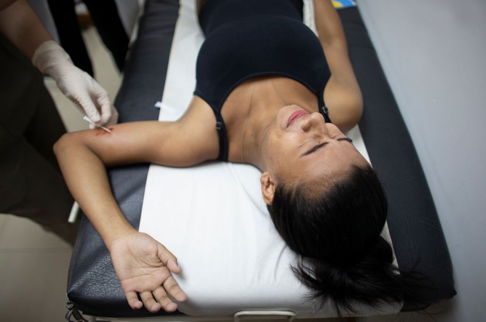 In this photo taken July 25, 2019, 18-year-old Yorselis Fajardo, who became a mother when she was 15, gets a hormonal implant on her arm to prevent pregnancies at a clinic in the Caucaguita neighborhood on the outskirts of Caracas, Venezuela. In a country where contraceptives are in short supply, word of the implants spread quickly, and while the lucky get on a list, the less fortunate hope there will be extras. (AP Photo/Ariana Cubillos) In this photo taken July 25, 2019, 18-year-old Yorselis Fajardo, who became a mother when she was 15, gets a hormonal implant on her arm to prevent pregnancies at a clinic in the Caucaguita neighborhood on the outskirts of Caracas, Venezuela. In a country where contraceptives are in short supply, word of the implants spread quickly, and while the lucky get on a list, the less fortunate hope there will be extras. (AP Photo/Ariana Cubillos)