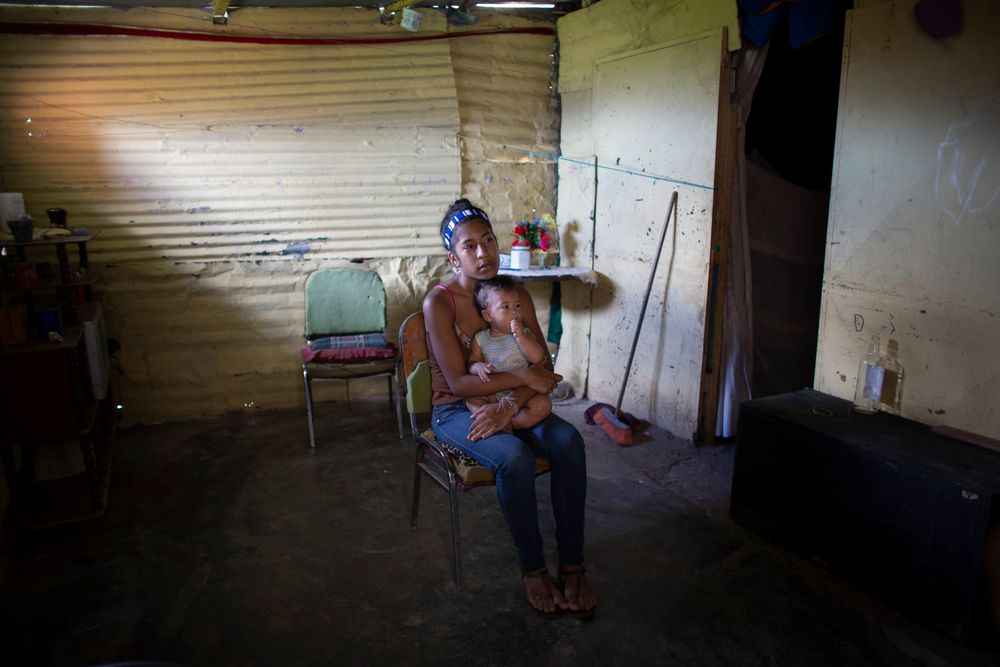 In this photo taken July 25, 2019, Karelys Herrera, 15, holds her baby inside her home during a interview in the Caucaguita neighborhood on the outskirts of Caracas, Venezuela. Herrera said she contemplated suicide after learning she was pregnant at age 14. (AP Photo/Ariana Cubillos) In this photo taken July 25, 2019, Karelys Herrera, 15, holds her baby inside her home during a interview in the Caucaguita neighborhood on the outskirts of Caracas, Venezuela. Herrera said she contemplated suicide after learning she was pregnant at age 14. (AP Photo/Ariana Cubillos)