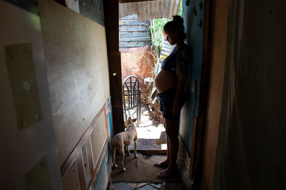 In this photo taken Aug. 5, 2019, 14-year-old Rosibeth Vargas, who is seven months pregnant, stands inside her home where she lives with her parents, 18-year-old sister and nephew, in the Tablitas area of the Caucaguita neighborhood on the outskirts of Caracas, Venezuela. Vargas said her school allows student mothers to bring their children to class, but that she dropped out after being bullied. (AP Photo/Ariana Cubillos) In this photo taken Aug. 5, 2019, 14-year-old Rosibeth Vargas, who is seven months pregnant, stands inside her home where she lives with her parents, 18-year-old sister and nephew, in the Tablitas area of the Caucaguita neighborhood on the outskirts of Caracas, Venezuela. Vargas said her school allows student mothers to bring their children to class, but that she dropped out after being bullied. (AP Photo/Ariana Cubillos)