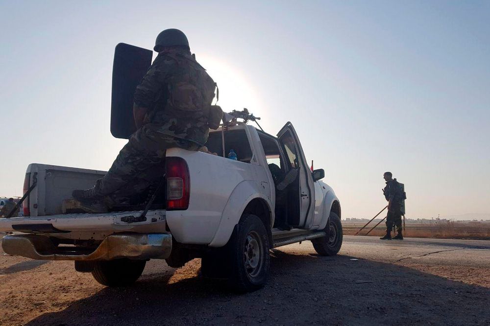 In this photo released by the Syrian official news agency SANA, Syrian troops deploy in the northern town of Tal Tamr, Monday, Oct 14, 2019. The move toward Tal Tamr came a day after Syria's Kurds said Syrian government forces agreed to help them fend off Turkey's invasion — a major shift in alliances that came after President Donald Trump ordered all U.S. troops withdrawn from the northern border area amid the rapidly deepening chaos. (SANA via AP) In this photo released by the Syrian official news agency SANA, Syrian troops deploy in the northern town of Tal Tamr, Monday, Oct 14, 2019. The move toward Tal Tamr came a day after Syria's Kurds said Syrian government forces agreed to help them fend off Turkey's invasion — a major shift in alliances that came after President Donald Trump ordered all U.S. troops withdrawn from the northern border area amid the rapidly deepening chaos. (SANA via AP)