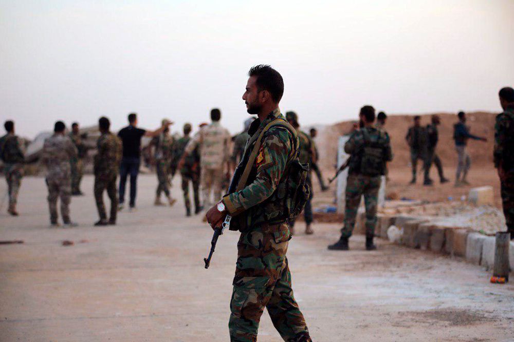 In this Monday, Oct. 14, 2019, photo, released by the Syrian official news agency SANA, Syrian troops deploy in the Tabqa airbase in Raqqa, Syria. SANA said Monday that in addition to Tabqa and its airbase that carries the same name, Syrian troops entered several other villages on the southern parts of Raqqa province. (SANA via AP) In this Monday, Oct. 14, 2019, photo, released by the Syrian official news agency SANA, Syrian troops deploy in the Tabqa airbase in Raqqa, Syria. SANA said Monday that in addition to Tabqa and its airbase that carries the same name, Syrian troops entered several other villages on the southern parts of Raqqa province. (SANA via AP)