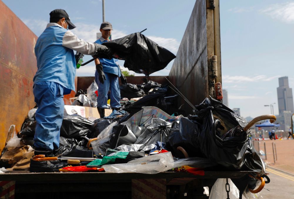Workers clean up broken umbrellas left in the aftermath of Wednesday's violent protest against the proposed amendments to extradition law near the Legislative Council in Hong Kong on Friday, June 14, 2019. Calm appeared to have returned to Hong Kong after days of protests by students and human rights activists opposed to a bill that would allow suspects to be tried in mainland Chinese courts. (AP Photo/Vincent Yu) Workers clean up broken umbrellas left in the aftermath of Wednesday's violent protest against the proposed amendments to extradition law near the Legislative Council in Hong Kong on Friday, June 14, 2019. Calm appeared to have returned to Hong Kong after days of protests by students and human rights activists opposed to a bill that would allow suspects to be tried in mainland Chinese courts. (AP Photo/Vincent Yu)