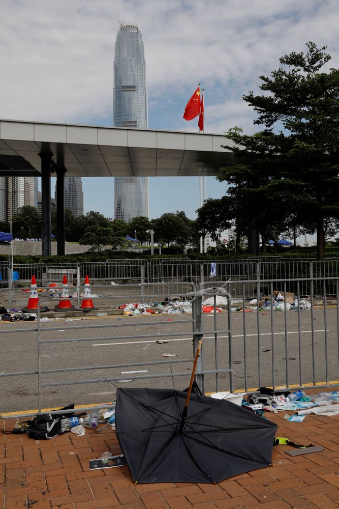 A broken umbrella left in the aftermath of Wednesday's violent protest against proposed amendments to an extradition law is seen near the Chinese flag in Hong Kong on Friday, June 14, 2019. Calm appeared to have returned to Hong Kong after days of protests by students and human rights activists opposed to a bill that would allow suspects to be tried in mainland Chinese courts. (AP Photo/Vincent Yu) A broken umbrella left in the aftermath of Wednesday's violent protest against proposed amendments to an extradition law is seen near the Chinese flag in Hong Kong on Friday, June 14, 2019. Calm appeared to have returned to Hong Kong after days of protests by students and human rights activists opposed to a bill that would allow suspects to be tried in mainland Chinese courts. (AP Photo/Vincent Yu)