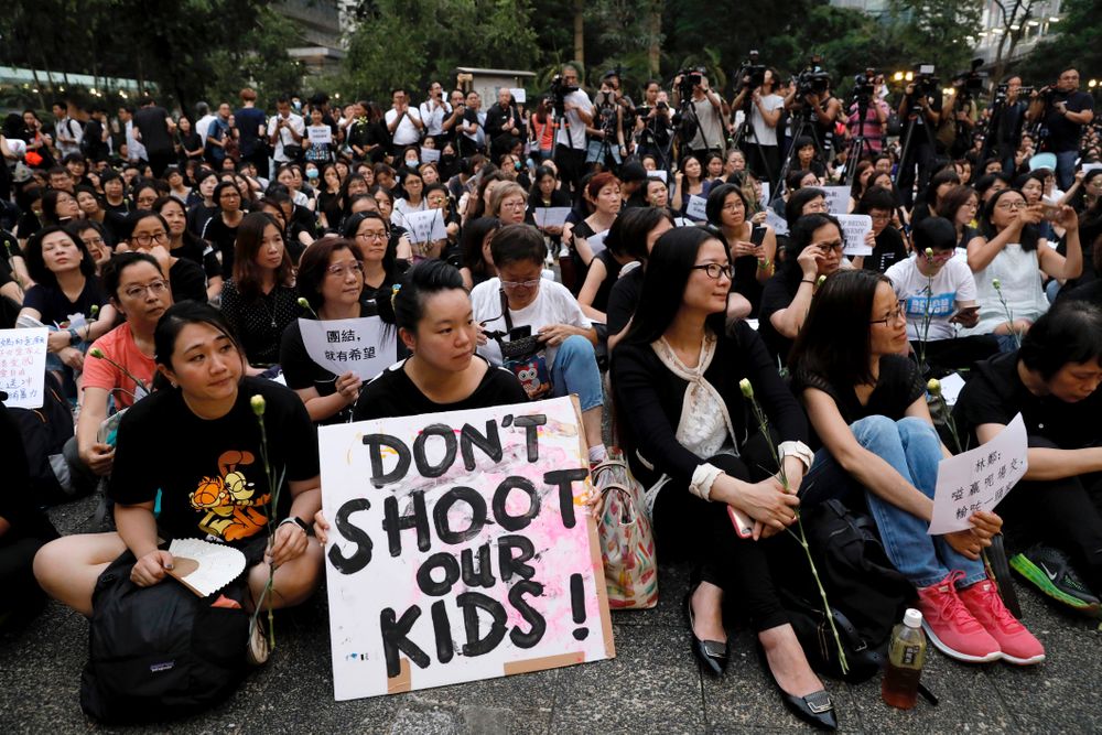 Hundreds of mothers protest against the amendments to the extradition law after Wednesday's violent protest in Hong Kong on Friday, June 14, 2019. Calm appeared to have returned to Hong Kong after days of protests by students and human rights activists opposed to a bill that would allow suspects to be tried in mainland Chinese courts. (AP Photo/Vincent Yu) Hundreds of mothers protest against the amendments to the extradition law after Wednesday's violent protest in Hong Kong on Friday, June 14, 2019. Calm appeared to have returned to Hong Kong after days of protests by students and human rights activists opposed to a bill that would allow suspects to be tried in mainland Chinese courts. (AP Photo/Vincent Yu)