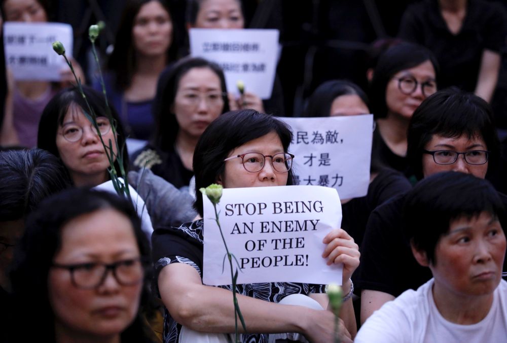 Hundreds of mothers protest against the amendments to the extradition law after Wednesday's violent protest in Hong Kong on Friday, June 14, 2019. Calm appeared to have returned to Hong Kong after days of protests by students and human rights activists opposed to a bill that would allow suspects to be tried in mainland Chinese courts. (AP Photo/Vincent Yu) Hundreds of mothers protest against the amendments to the extradition law after Wednesday's violent protest in Hong Kong on Friday, June 14, 2019. Calm appeared to have returned to Hong Kong after days of protests by students and human rights activists opposed to a bill that would allow suspects to be tried in mainland Chinese courts. (AP Photo/Vincent Yu)