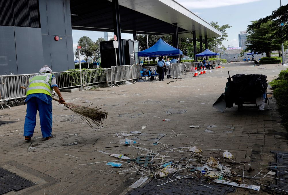 A worker cleans up in the aftermath of Wednesday's violent protest against the proposed amendments to extradition law near the Legislative Council in Hong Kong on Friday, June 14, 2019. Calm appeared to have returned to Hong Kong after days of protests by students and human rights activists opposed to a bill that would allow suspects to be tried in mainland Chinese courts. (AP Photo/Vincent Yu) A worker cleans up in the aftermath of Wednesday's violent protest against the proposed amendments to extradition law near the Legislative Council in Hong Kong on Friday, June 14, 2019. Calm appeared to have returned to Hong Kong after days of protests by students and human rights activists opposed to a bill that would allow suspects to be tried in mainland Chinese courts. (AP Photo/Vincent Yu)