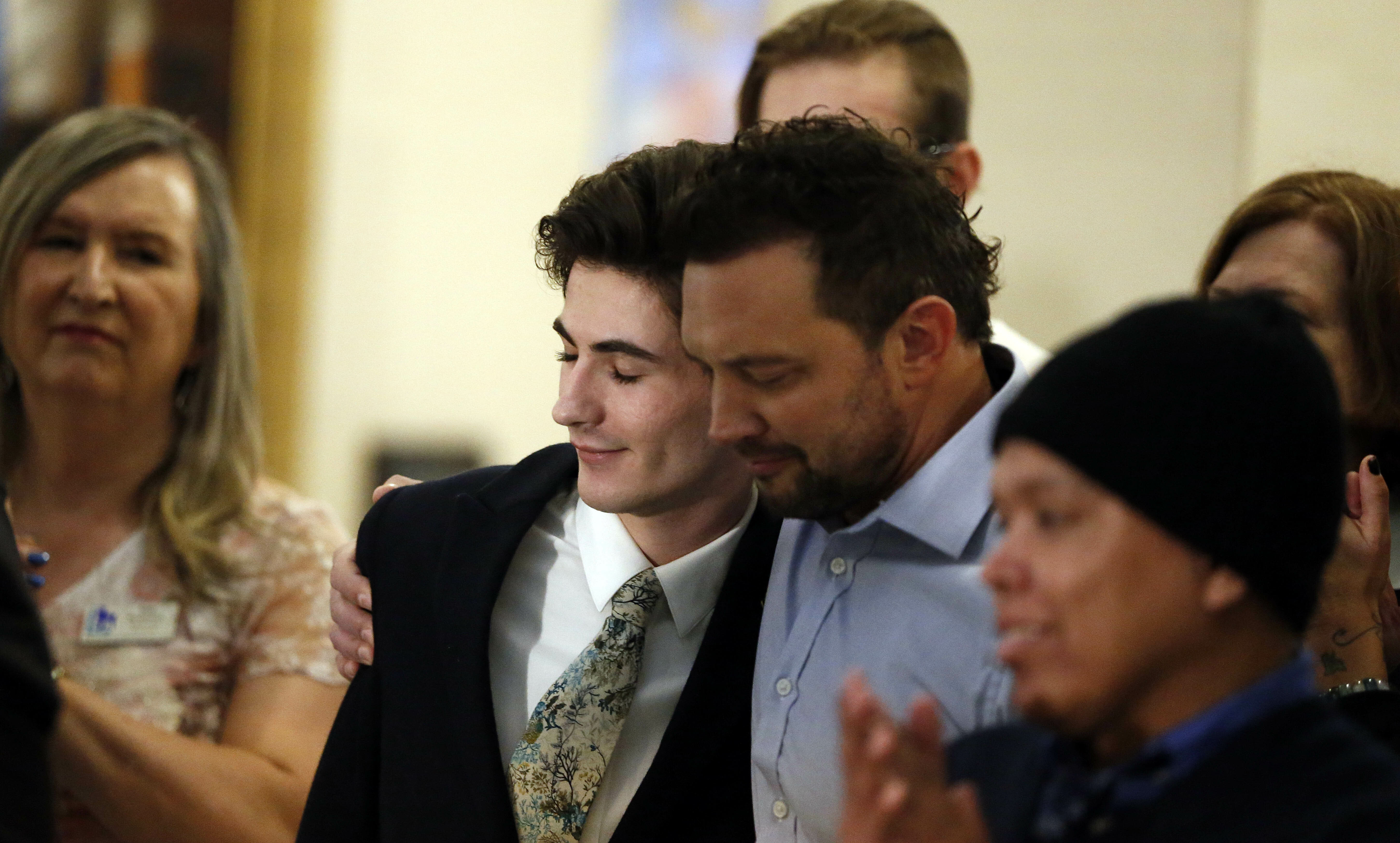 Nathan Dalley, center, receives a hug after speaking during a news conference at the Utah State Capitol Thursday, Feb. 21, 2019, in Salt Lake City. Two Republican lawmakers proposed a ban on gay conversion therapy for minors in conservative Utah on Thursday, a plan that's been hailed as a milestone by advocates and won't be opposed by the influential Mormon church. Those who have been through conversion therapy, like 19-year-old Dalley, say it leaves them depressed and can lead to suicide attempts. (AP Photo/Rick Bowmer) Nathan Dalley, center, receives a hug after speaking during a news conference at the Utah State Capitol Thursday, Feb. 21, 2019, in Salt Lake City. Two Republican lawmakers proposed a ban on gay conversion therapy for minors in conservative Utah on Thursday, a plan that's been hailed as a milestone by advocates and won't be opposed by the influential Mormon church. Those who have been through conversion therapy, like 19-year-old Dalley, say it leaves them depressed and can lead to suicide attempts. (AP Photo/Rick Bowmer)