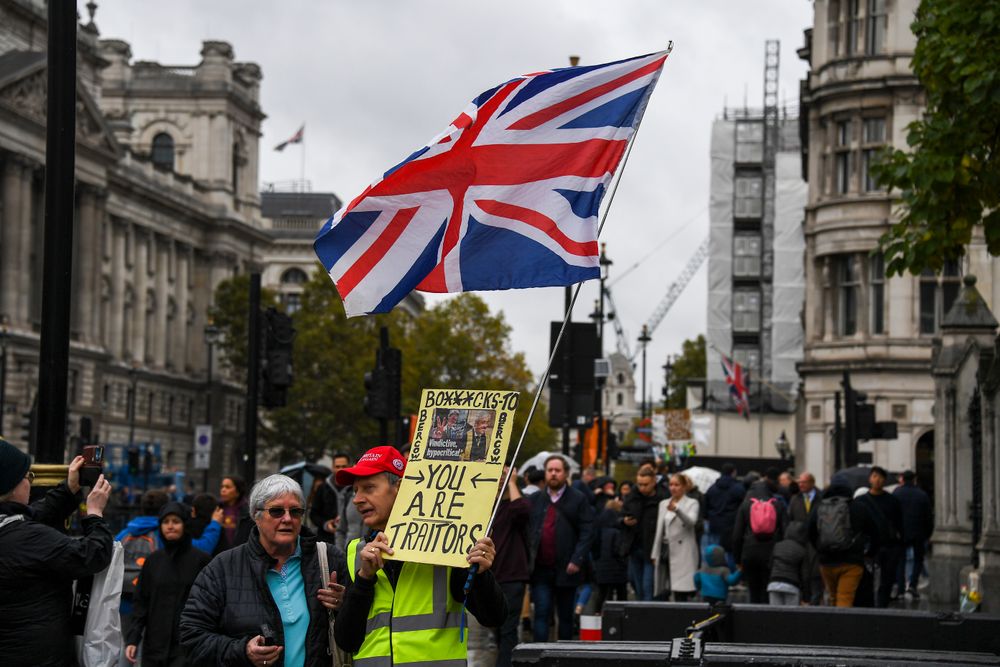 A pro Brexit demonstrator protests outside the Houses of Parliament, holding a placard and a Union flag, in London, Monday, Oct. 21, 2019. The European Commission says the fact that British Prime Minister Boris Johnson did not sign a letter requesting a three-month extension of the Brexit deadline has no impact on whether it is valid and that the European Union is considering the request. (AP Photo/Alberto Pezzali) A pro Brexit demonstrator protests outside the Houses of Parliament, holding a placard and a Union flag, in London, Monday, Oct. 21, 2019. The European Commission says the fact that British Prime Minister Boris Johnson did not sign a letter requesting a three-month extension of the Brexit deadline has no impact on whether it is valid and that the European Union is considering the request. (AP Photo/Alberto Pezzali)